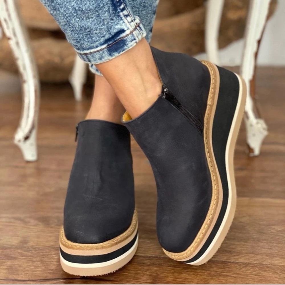 Black leather solid-wedge ankle boots.